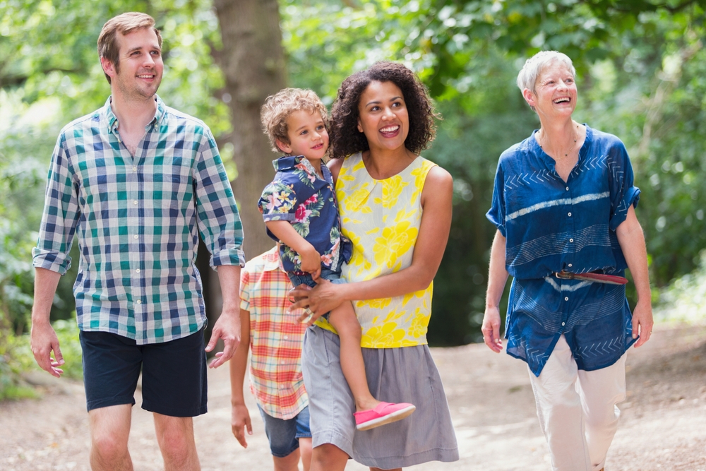 Multi-generation family walking in woods